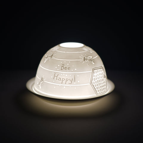 Cello porcelain tealight holder dome, in our bee happy design. This design displays the text "bee happy" surrounded by a bee back drop of the hive. We offer a wide range of porcelain tealight holders to let you choose your show stopping piece and show it off with pride when guests and family are over. Pick your preferred option between LED lights or using tealight candles. 